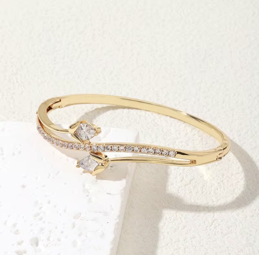 Woman wearing a stack of gold bangles