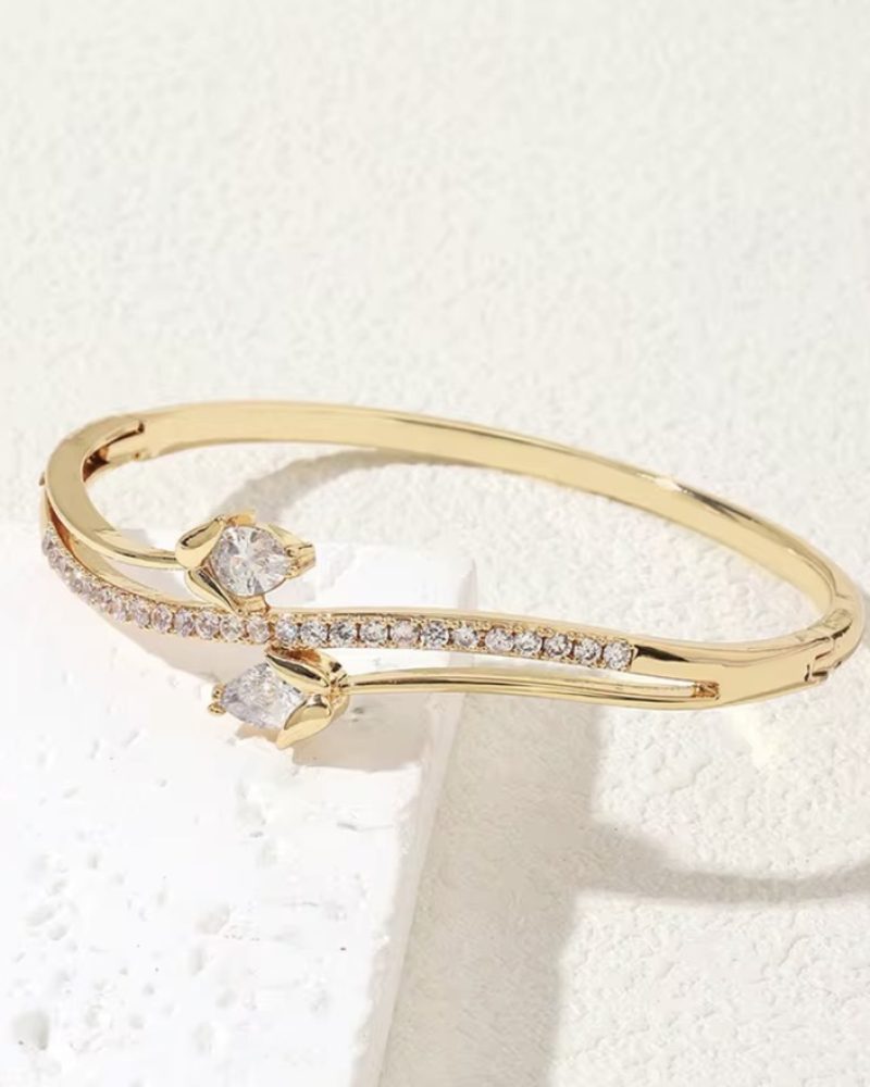 Woman wearing a stack of gold bangles