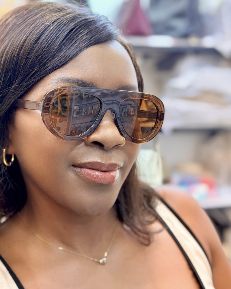 Lady wearing brown tinted sunglasses.